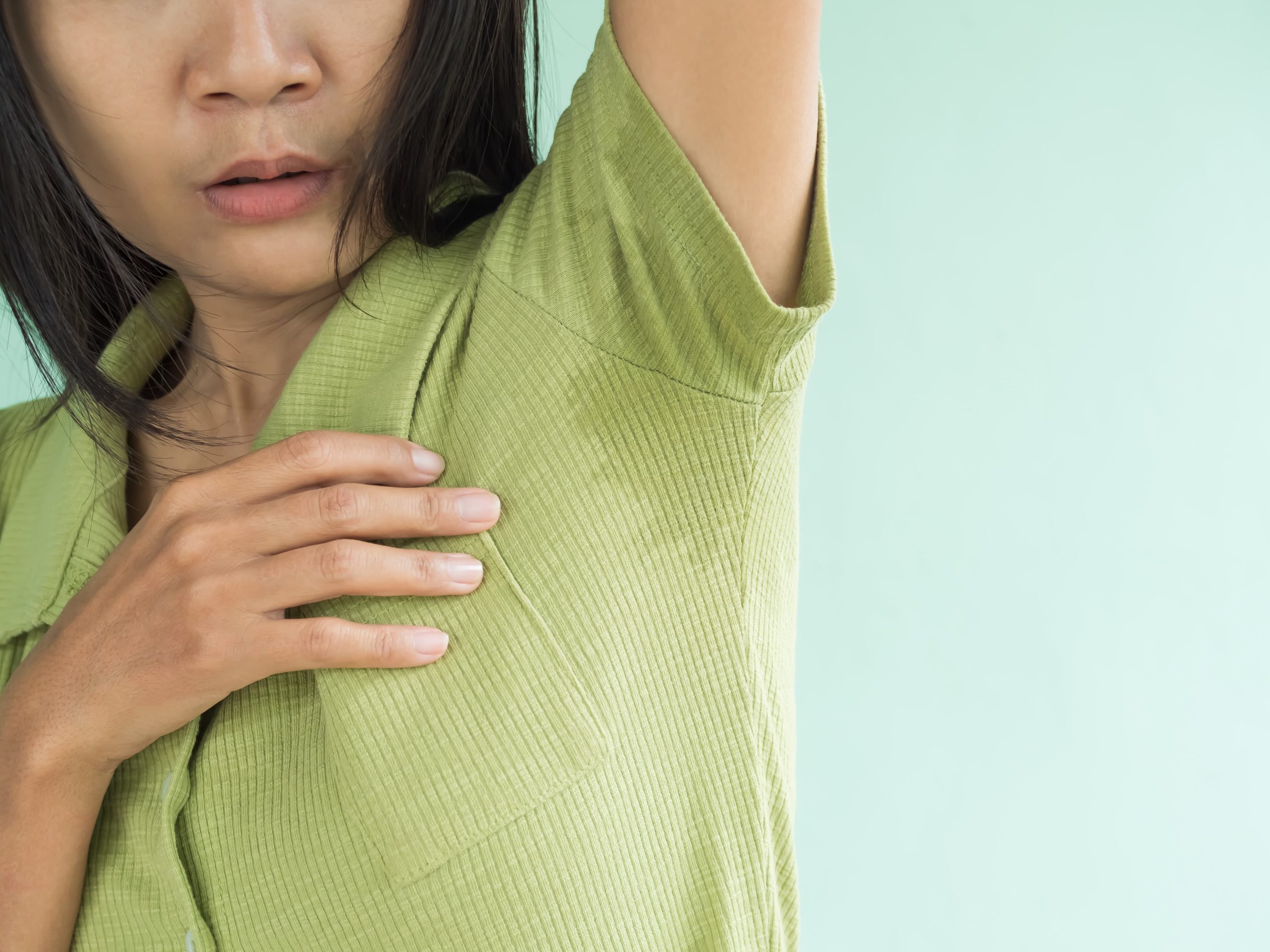 woman with hyperhidrosis sweating through shirt